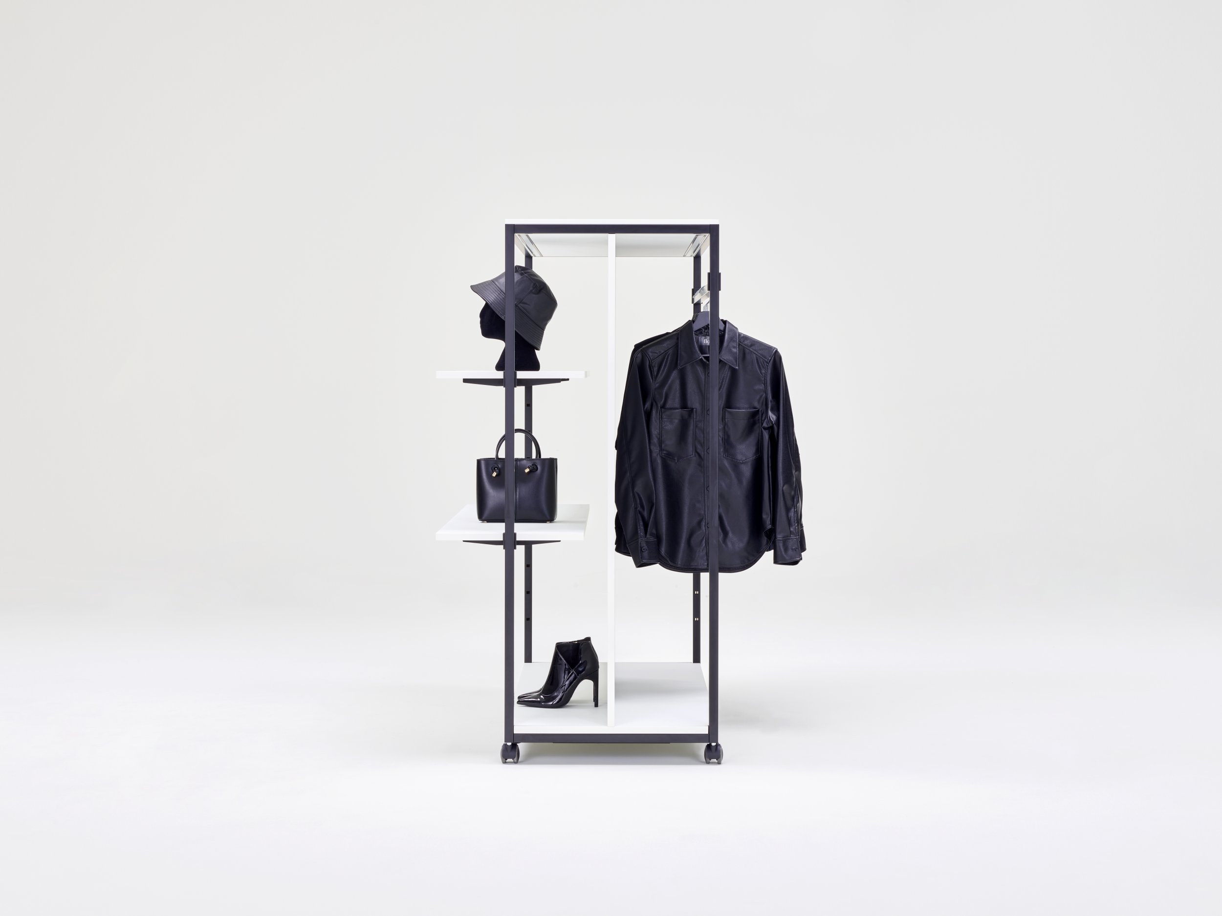 Clothing racks on castors with built-in shelves for the presentation of merchandise.