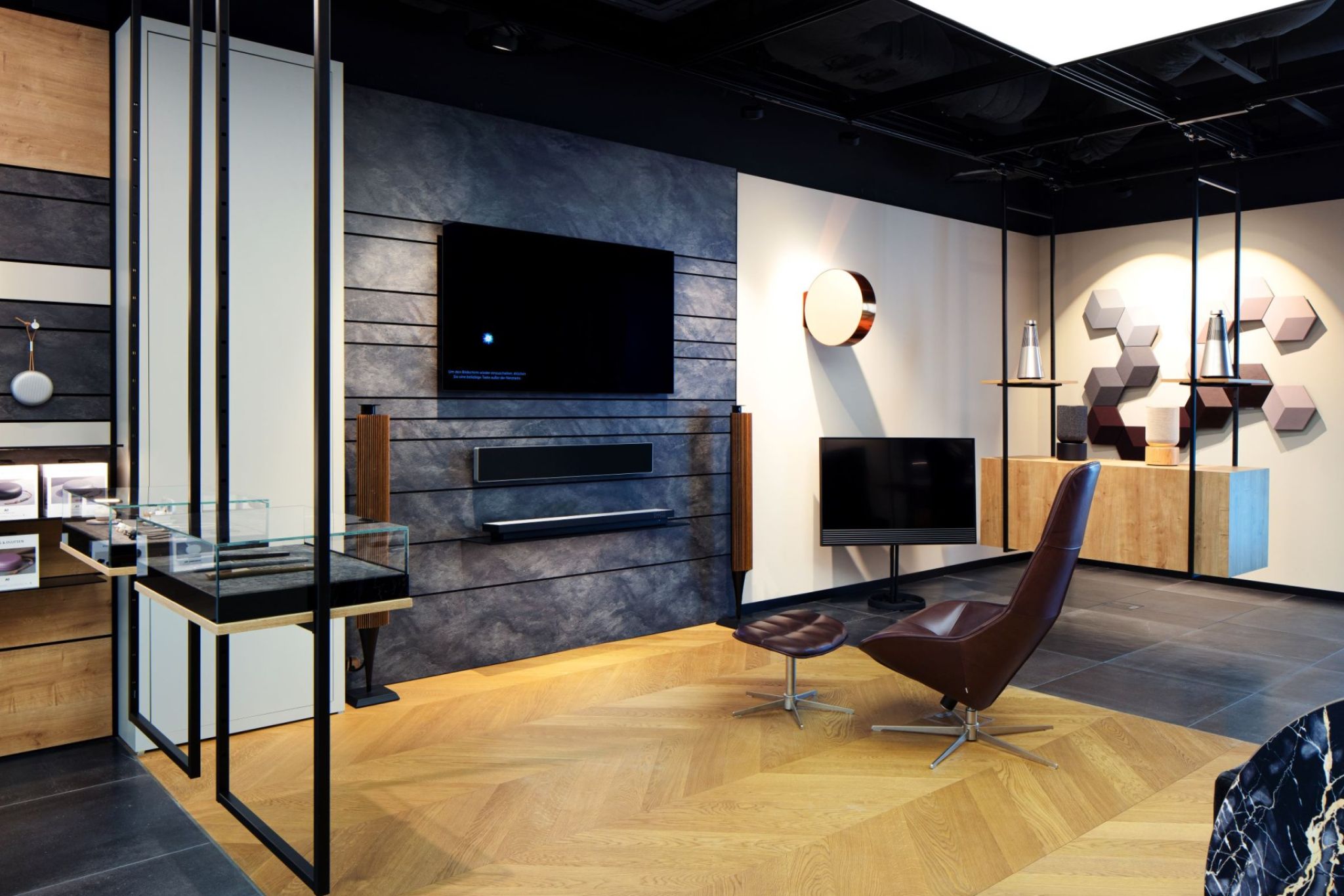 Lounge area of a commercial space equipped with an armchair and screen.