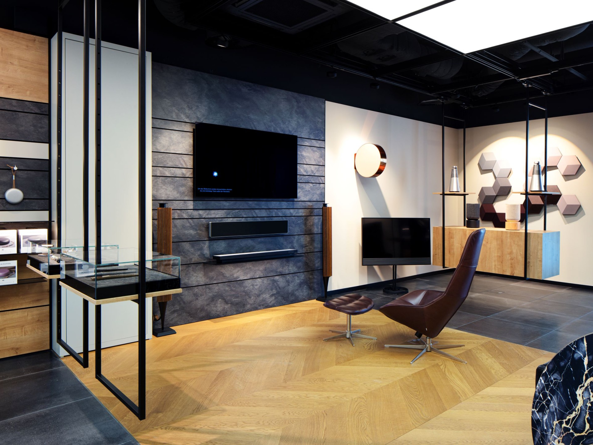 Lounge area of a commercial space equipped with an armchair and screen.