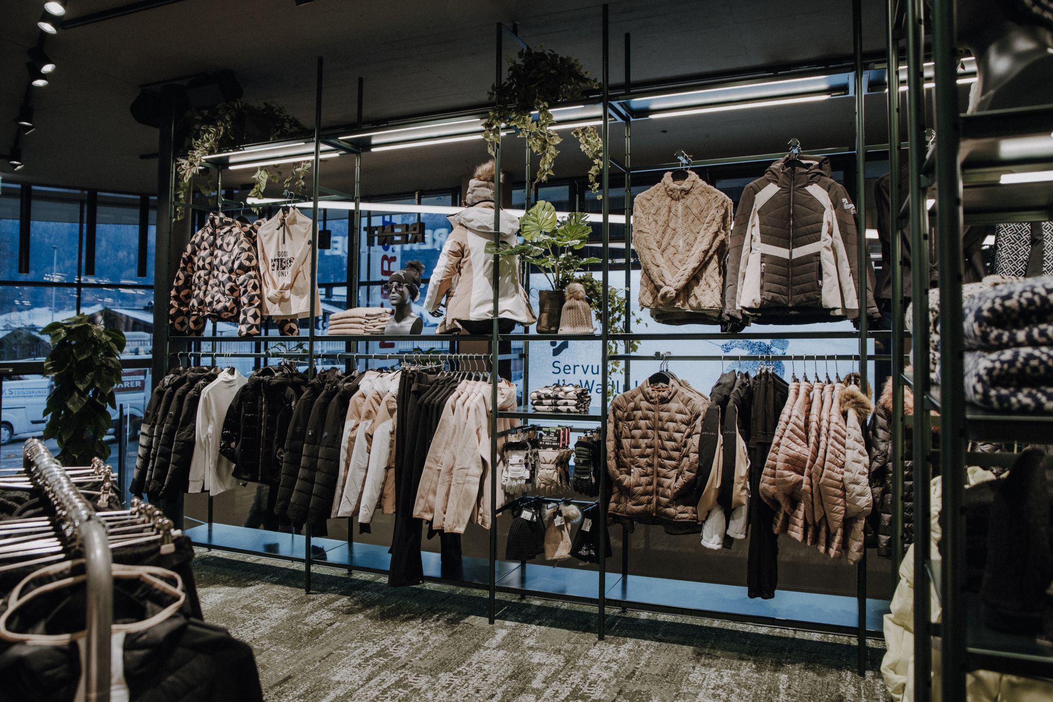 A modern sports store with open shelving systems, bright colors, and a dynamic presentation of sports equipment for an inspiring shopping experience.