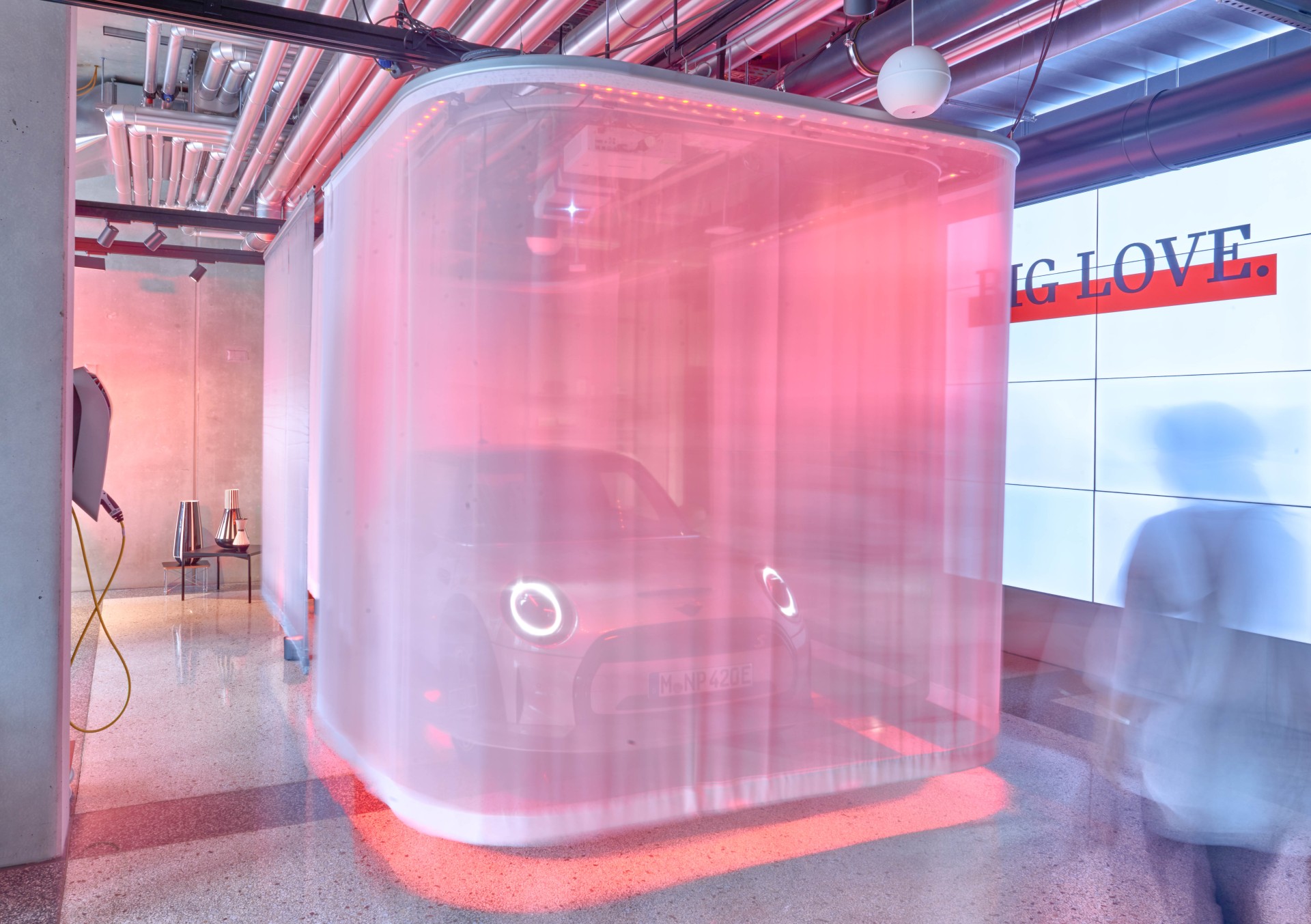 Vehicle of the car manufacturer MINI veiled behind a transparent curtain.
