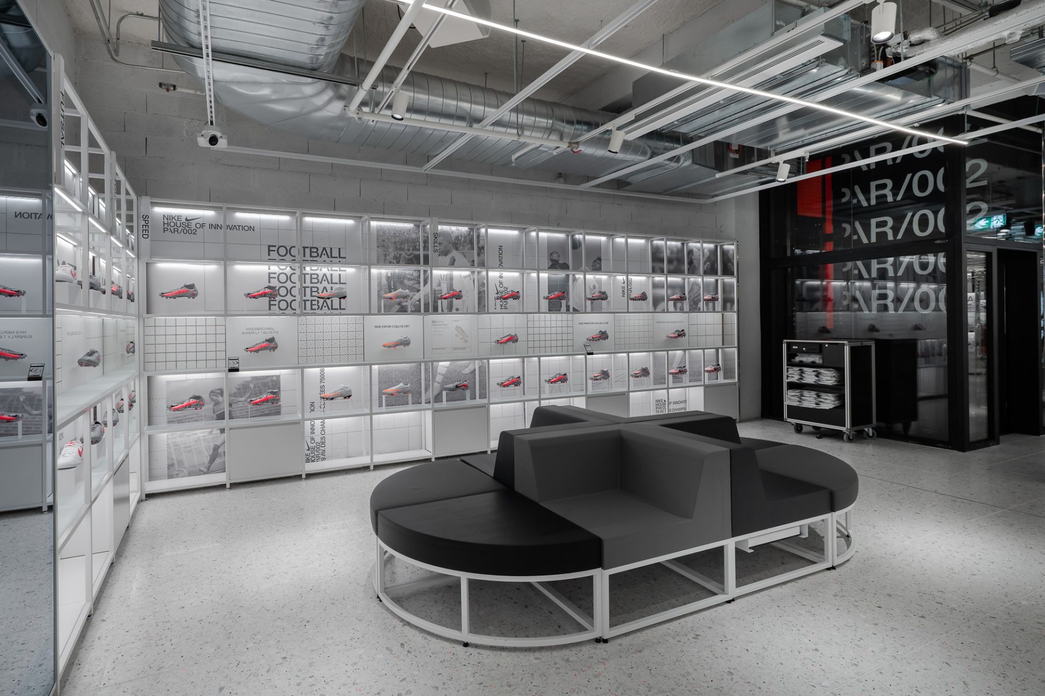 Modern room in a simple design with displayed soccer shoes.