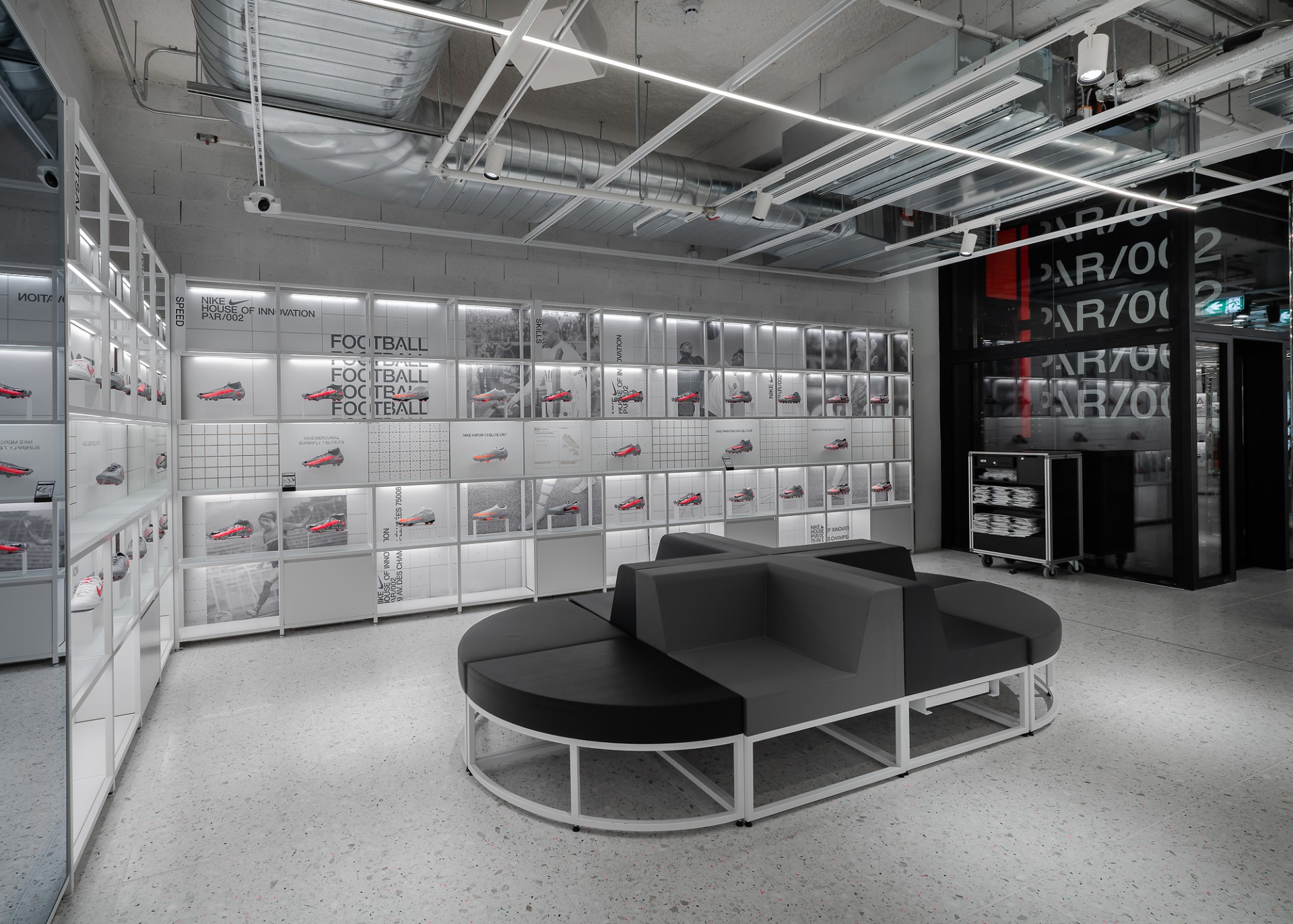 Modern room in a simple design with displayed soccer shoes.