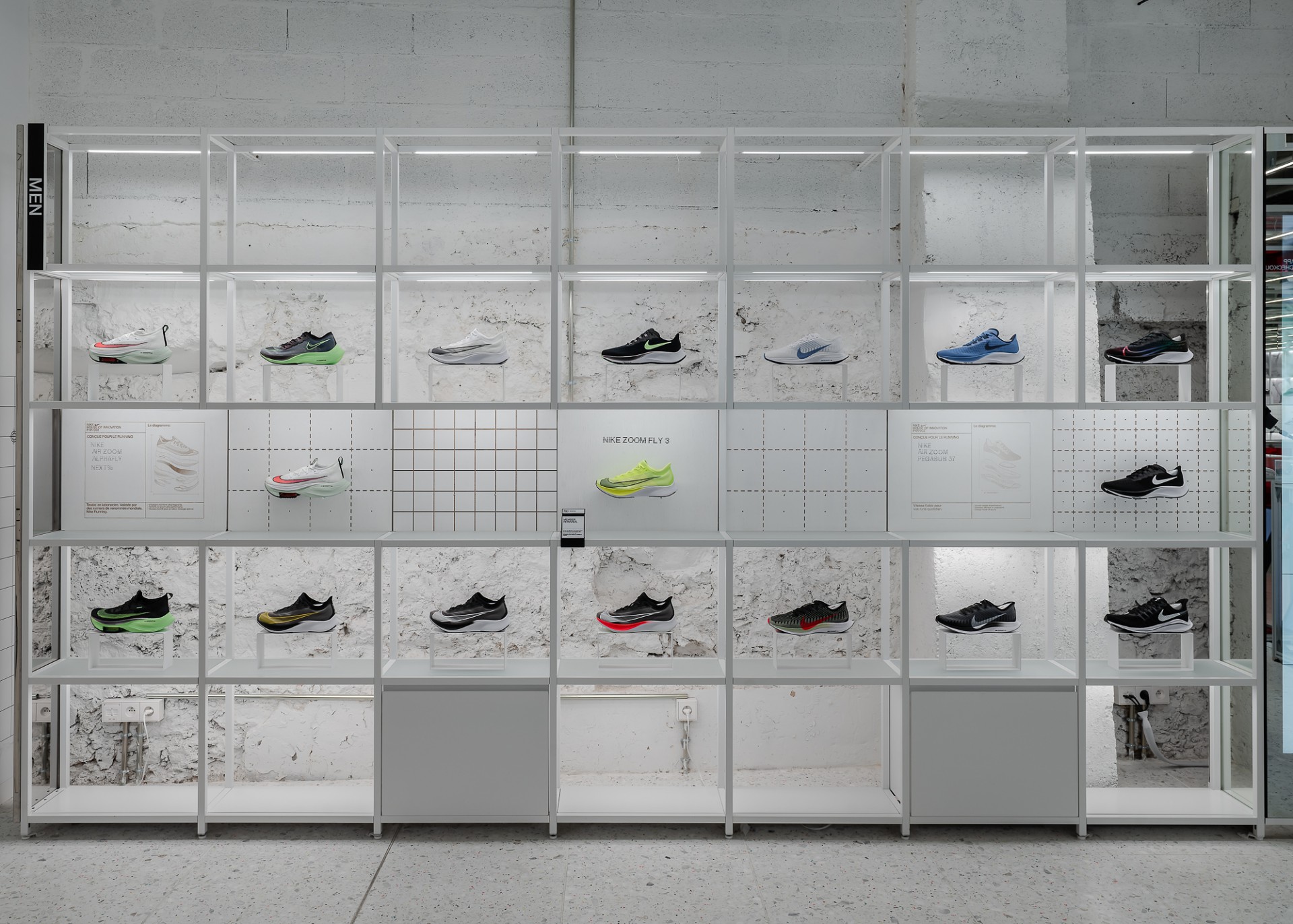 Bright shelf equipped with various sports shoes.