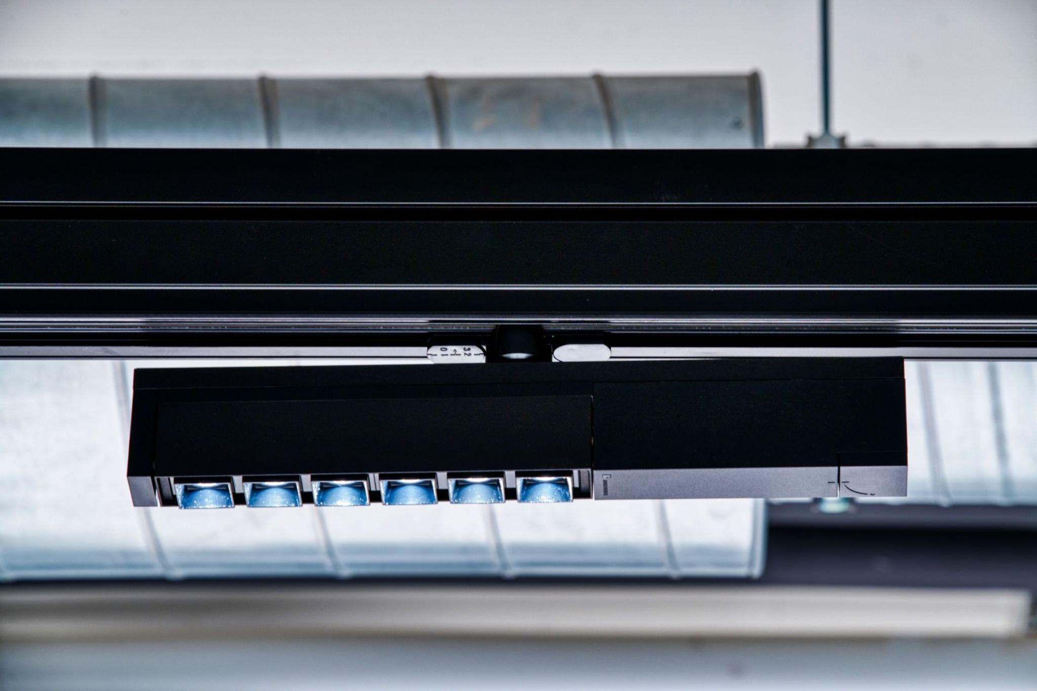 Close-up of an integrated lighting fixture in the ceiling rail system.