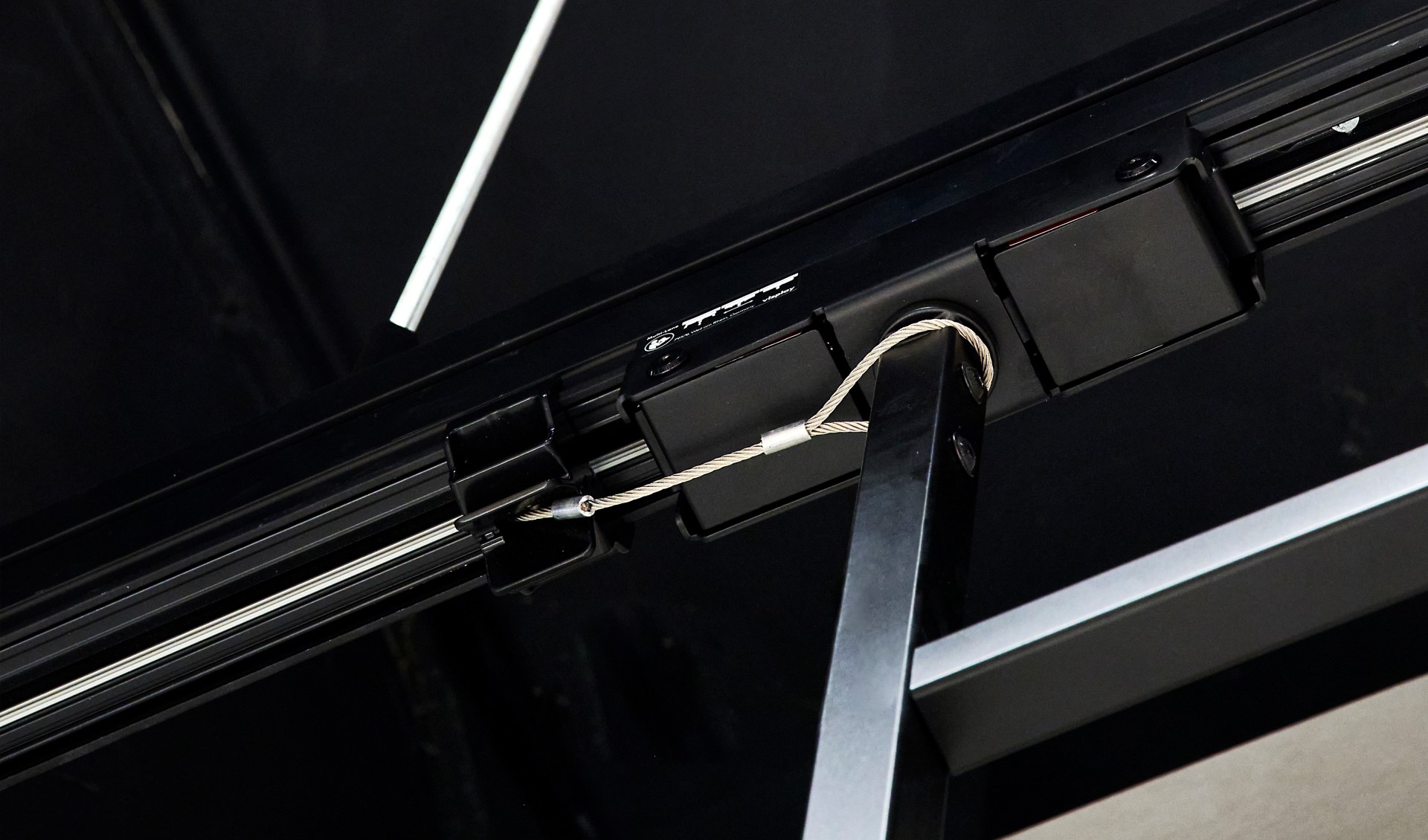 A black ceiling rail in detail.