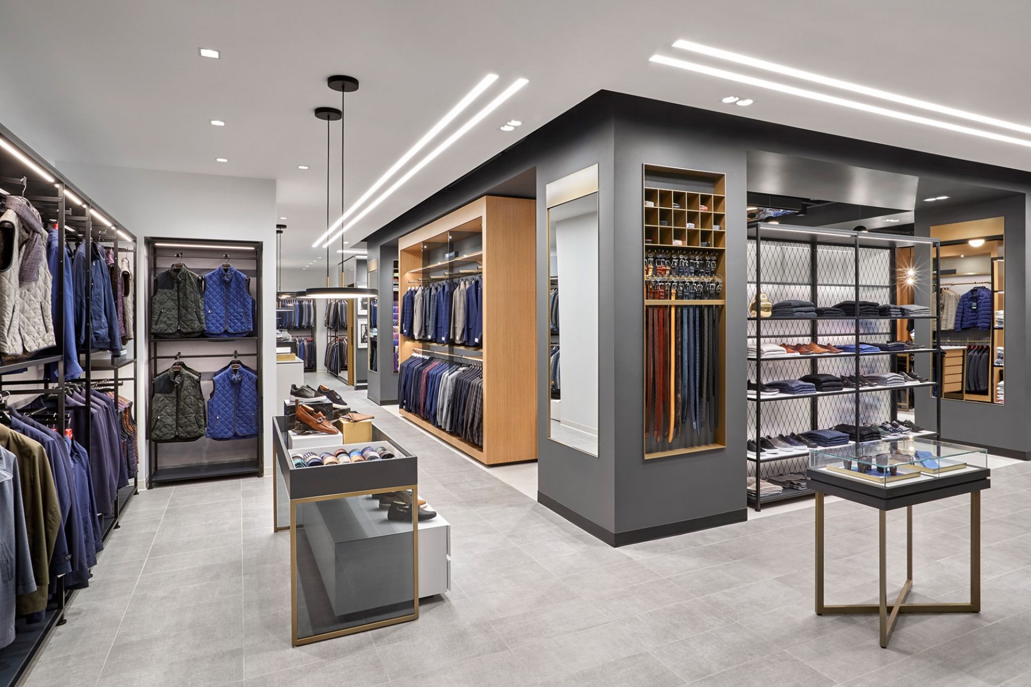 Elegant commercial space with merchandise carriers and men's fashion.