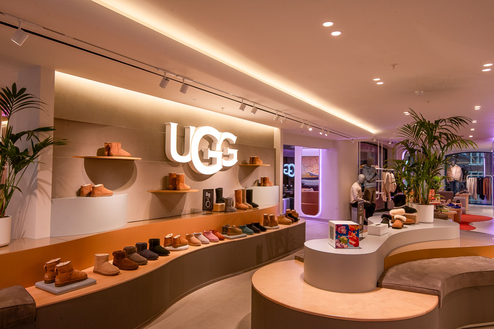 Modern shoe store with stylish shelving systems displaying high-quality products, surrounded by warm lighting and an elegant interior.