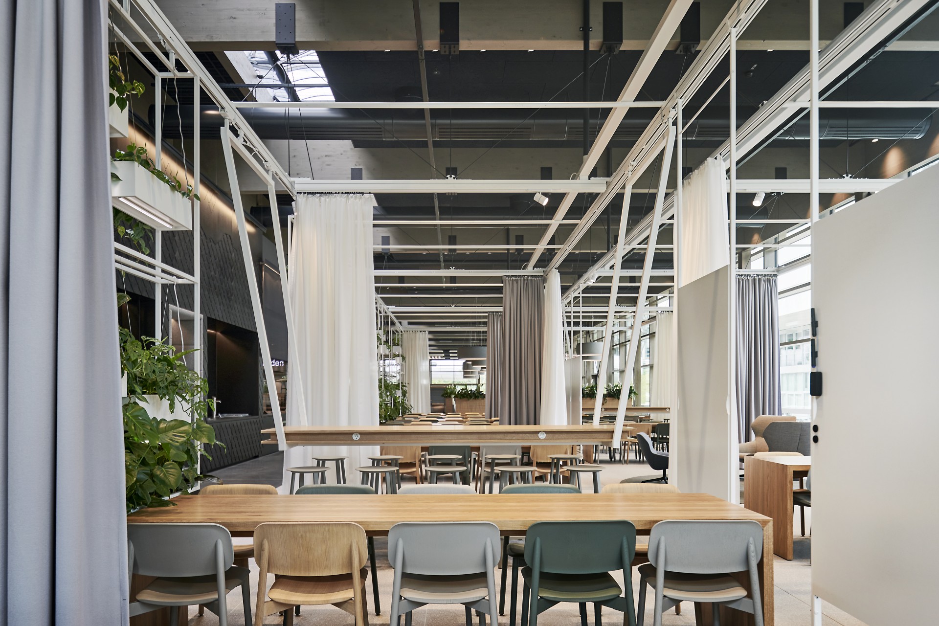 Detail view of the dining area of a canteen with curtains separating the room.