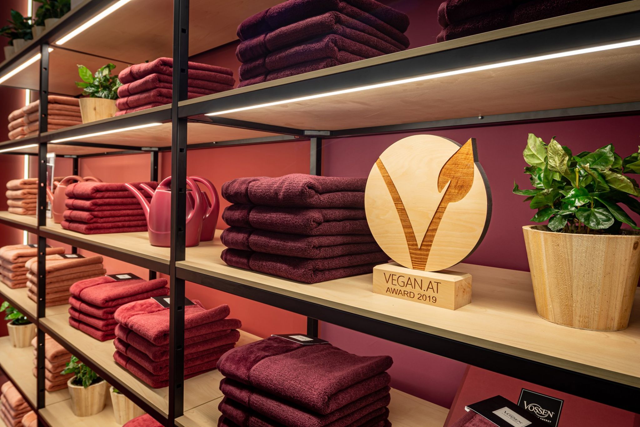 Red bath textiles placed on a shelf.